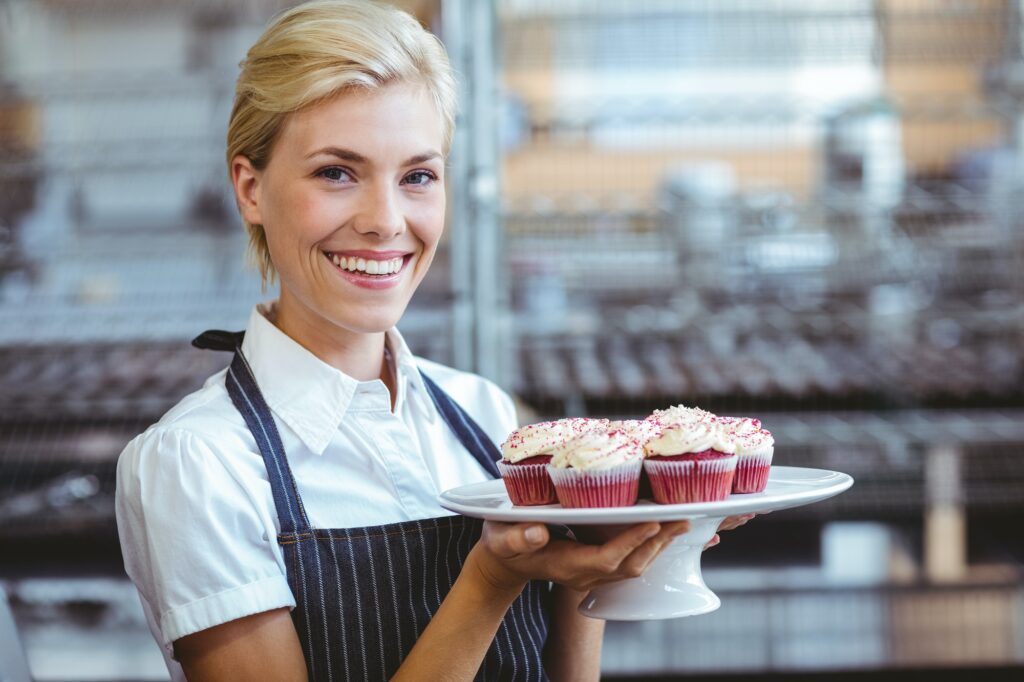 Happy pretty blonde showing her cake.jpg